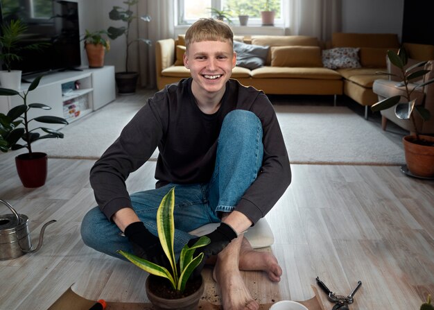 Full shot smiley man gardening indoors