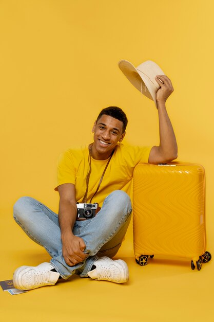 Full shot smiley man posing with baggage