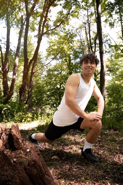 Full shot smiley man stretching in nature