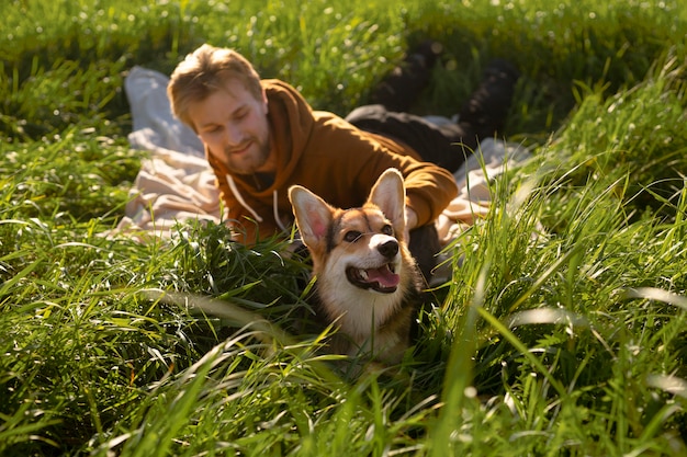 Free Photo full shot smiley man with dog in nature