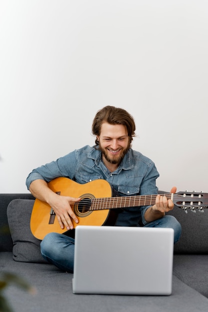 Full shot smiley man with guitar