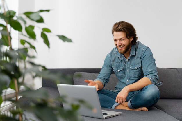 Full shot smiley man with laptop