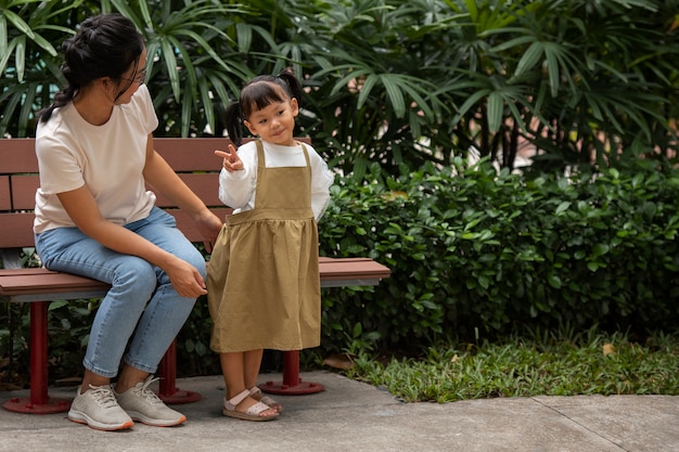 Full shot smiley mother and girl outdoors