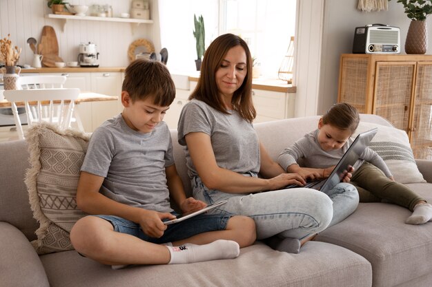 Full shot smiley mother with kids