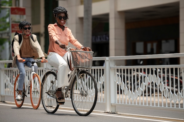 Full shot smiley people on bicycles