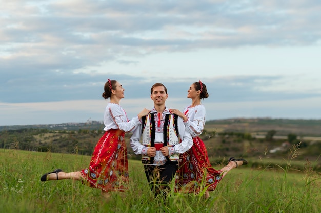 Full shot smiley people wearing traditional clothes