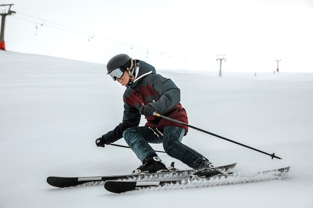 Full shot smiley skier with equipment