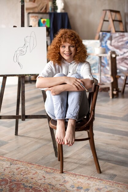 Full shot smiley woman on chair