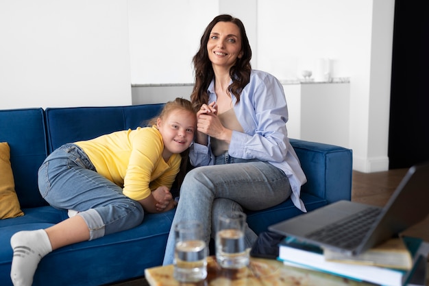 Full shot smiley woman and girl indoors