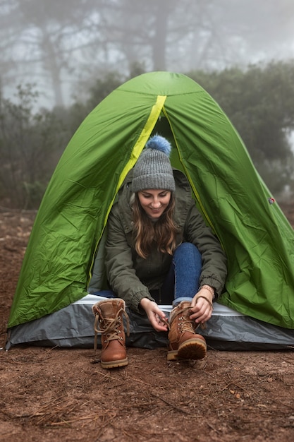 Free Photo full shot smiley woman going in tent