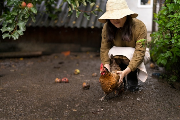 Free photo full shot smiley woman holding chick