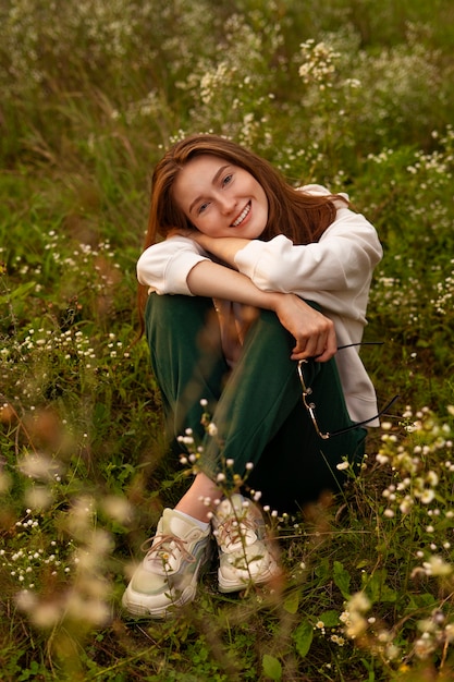 Full shot smiley woman posing outdoors