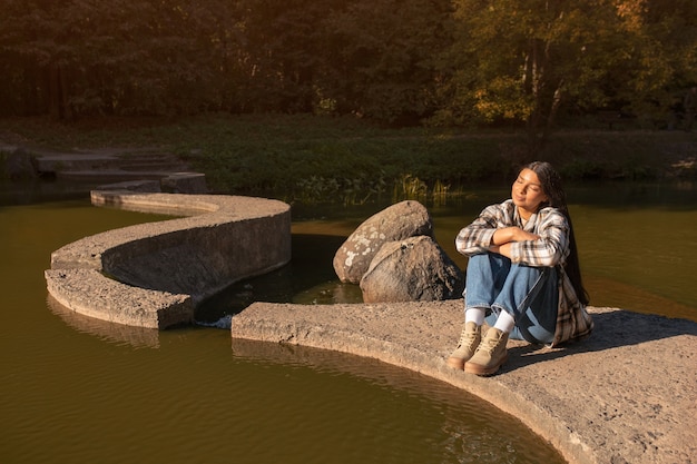 Free photo full shot smiley woman relaxing in nature