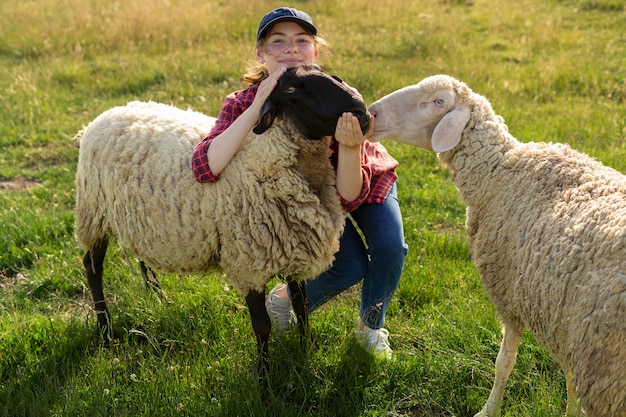 Full shot smiley woman and sheep