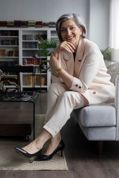 Full shot smiley woman sitting on couch