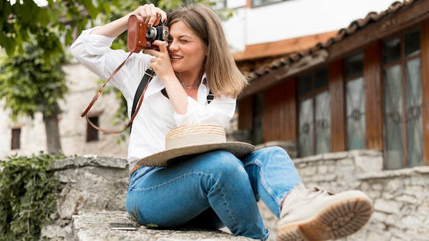 Full shot smiley woman taking photos