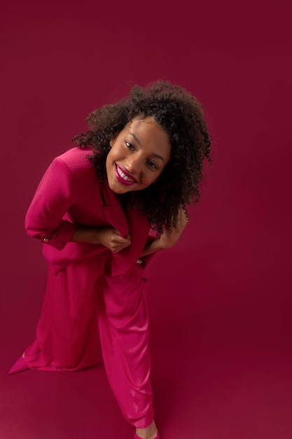 Full shot smiley woman with pink outfit