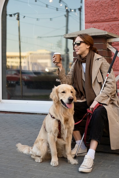 Free Photo full shot smiley woman with service dog