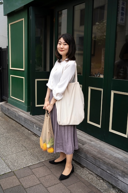 Full shot smiley woman with tote bag