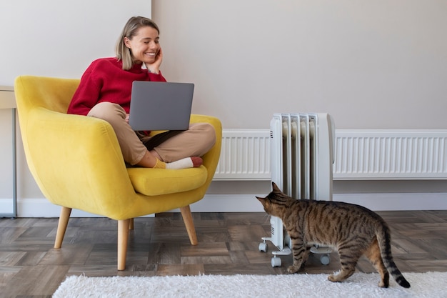 Full shot smiley woman working with laptop