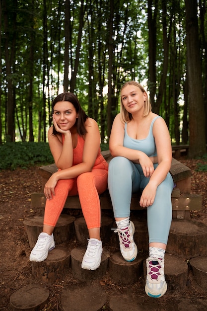 Full shot smiley women outdoors