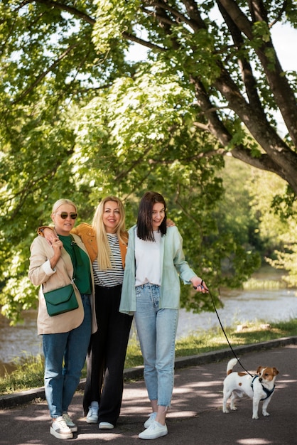 Full shot smiley women walking dog