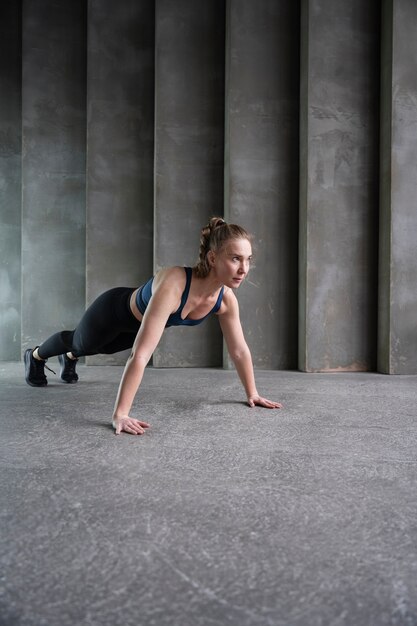 Full shot sporty woman exercising