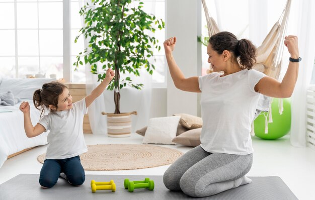 Full shot strong woman and kid