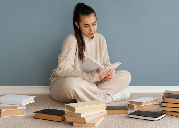 Full shot student with books on floor