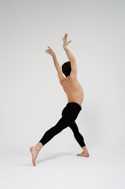 Full shot talented man dancing in studio