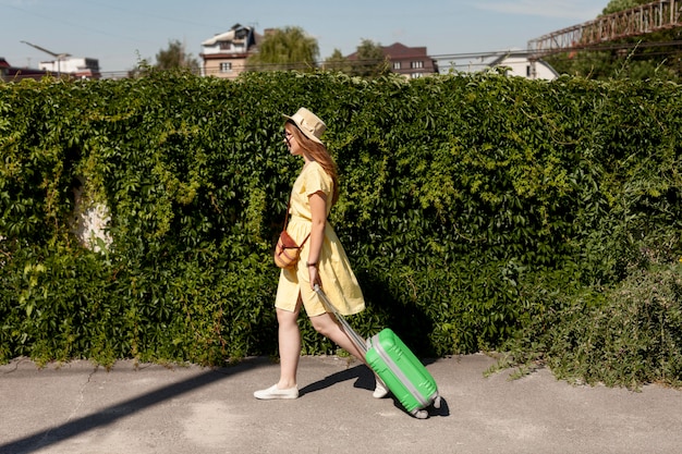 Free photo full shot tourist walking with luggage