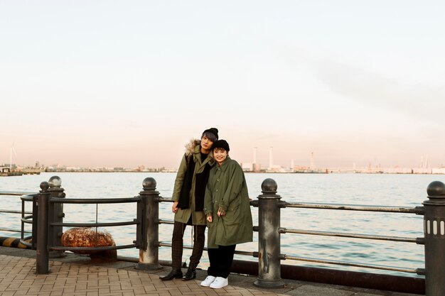 Full shot winter couple posing outdoors