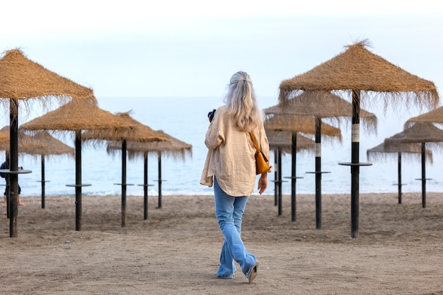 Free photo full shot woman on the beach