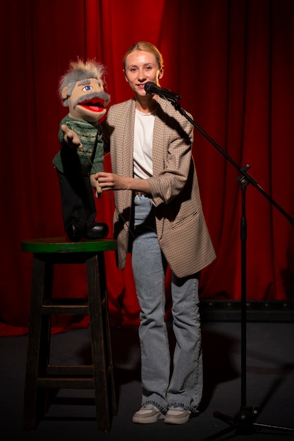 Free photo full shot woman being ventriloquist