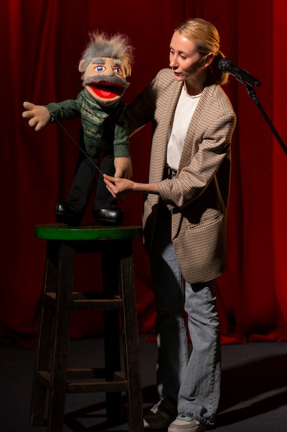 Full shot woman being ventriloquist