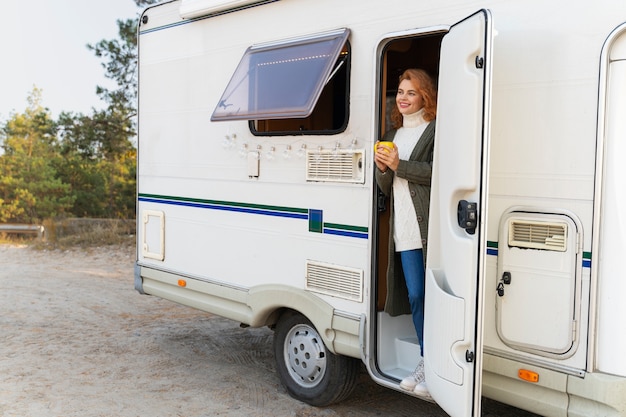 Free photo full shot woman in campervan