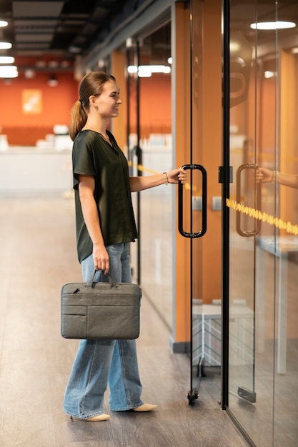 Free photo full shot woman carrying bag