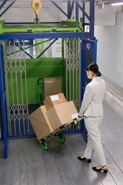 Free photo full shot woman carrying boxes