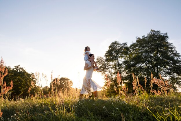 Full shot woman carrying girl