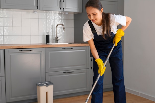 Full shot woman cleaning home