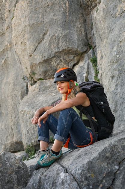 Full shot woman climbing in the mountains