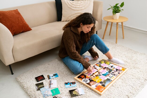 Full shot woman creating inspiring vision board