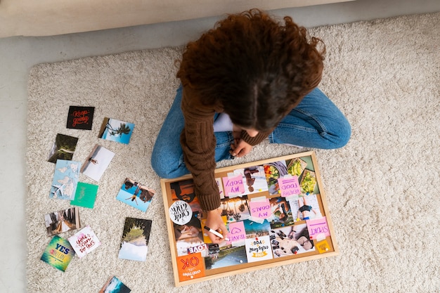 Full shot woman creating inspiring vision board