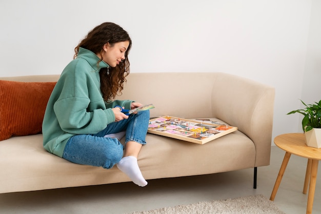 Full shot woman creating inspiring vision board