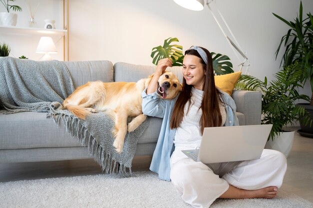 Full shot woman and cute dog at home