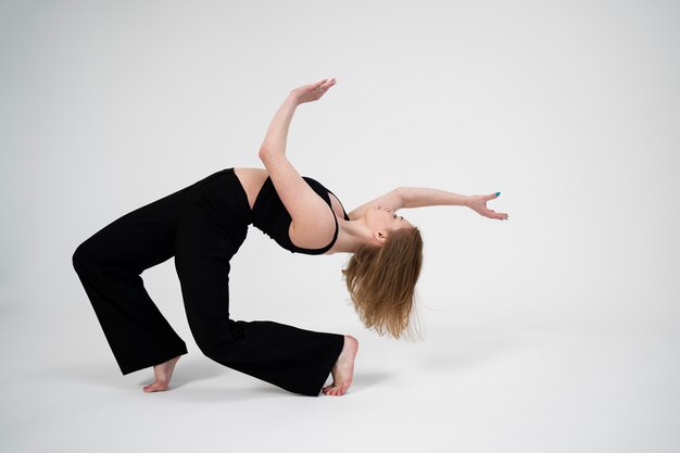 Full shot woman dancing in studio