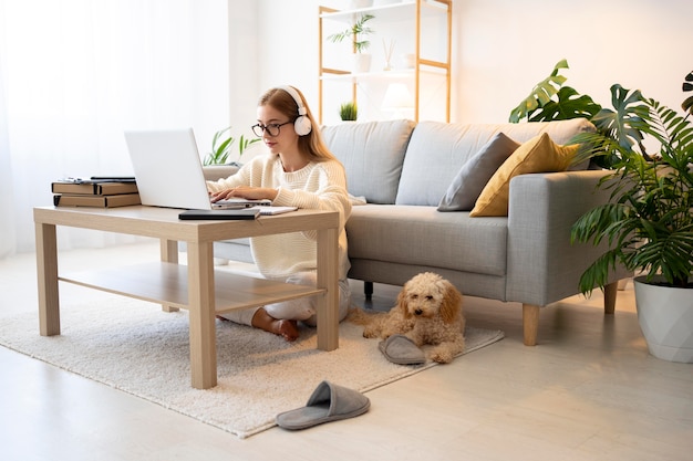 Full shot woman and dog at table