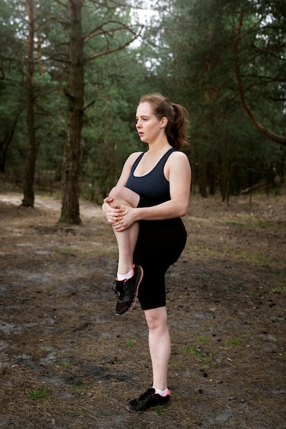 Full shot woman exercising outdoors