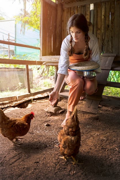 Full shot woman feeding birds