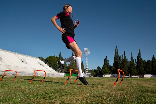 Full shot woman football player on field